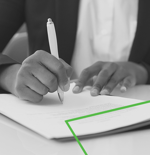 A woman writes on a piece of paper.