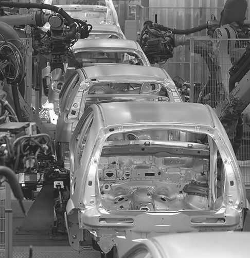 Cars being manufactured on an assembly line. 