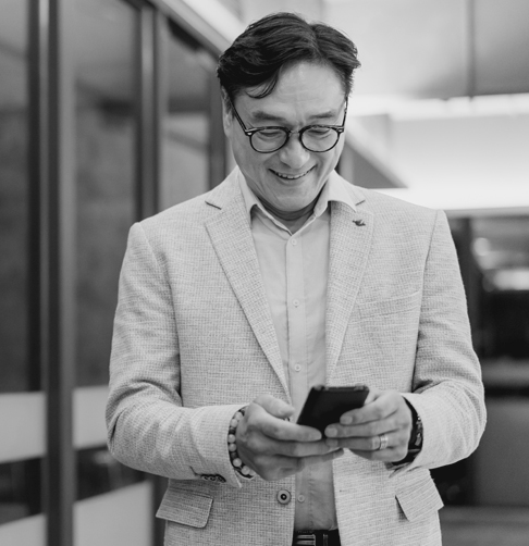 An advisor checks his mobile phone. 